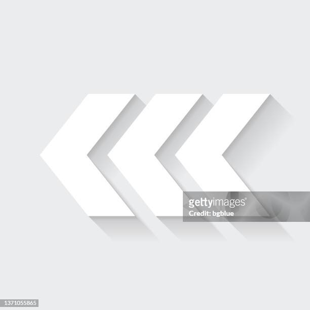 triple chevrons pointing left. icon with long shadow on blank background - flat design - chevron icon stock illustrations