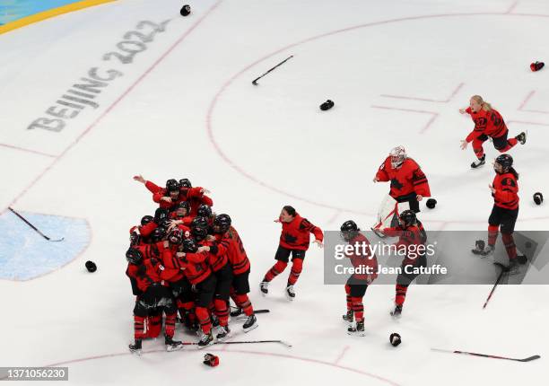 Players of Team Canada celebrate winning the Gold medal at final whistle following the Women's Ice Hockey Gold Medal match between Team Canada and...