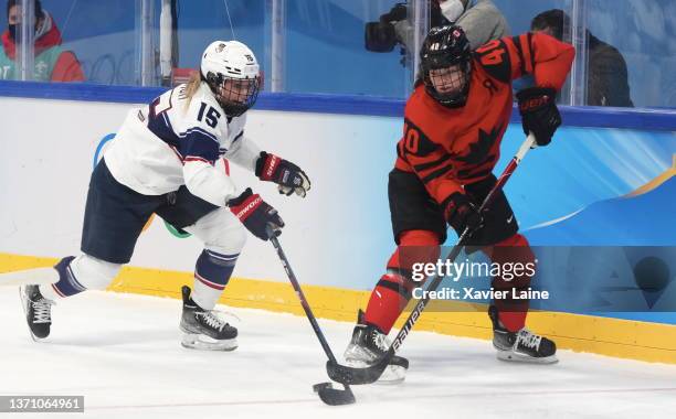 Savannah Harmon of Team United States in action with Blayre Turnbull of Team Canada during the Women's Ice Hockey Gold Medal match between Team...