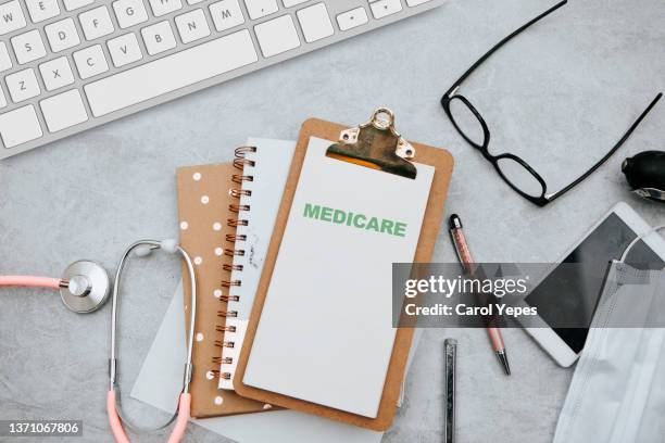 stethoscope with medicare form with parts list. - medicare stock pictures, royalty-free photos & images