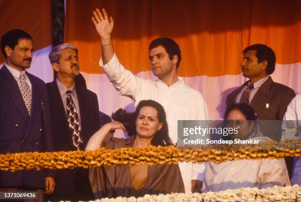 Congress party president Sonia Gandhi and her son Rahul Gandhi wave to their supporters during an election campaign public rally in Amethi district...