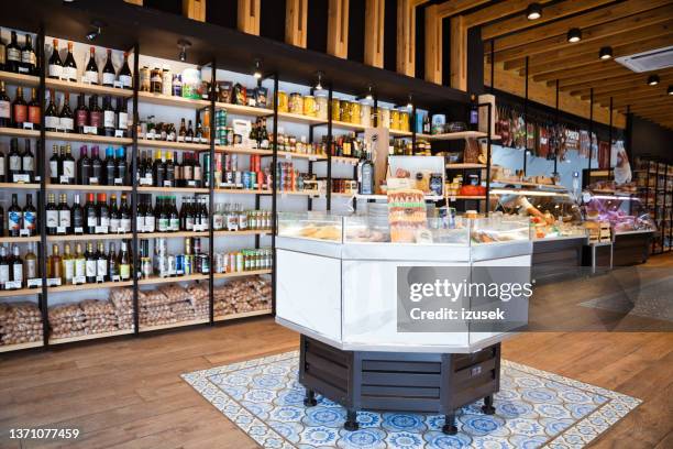 various wine bottles and food arranged on display - vitrinekast stockfoto's en -beelden