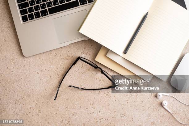 directly above shot of office desk and stationery on concrete background. flat lay - office work flat lay stock-fotos und bilder