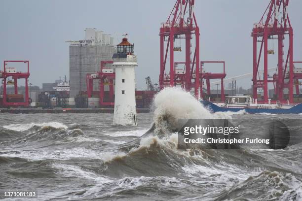 Waves created by high winds and Spring tides hit the sea wall at New Brighton promenade on February 17, 2022 in Liverpool, England. A red alert has...