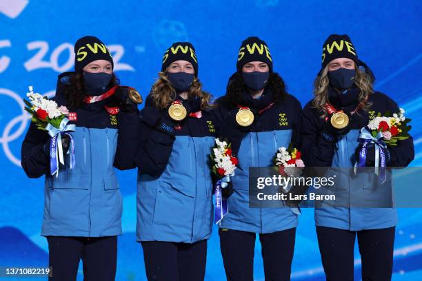 Gold medallists Linn Persson, Mona Brorsson, Hanna Oeberg and Elvira Oeberg of Team Sweden pose with their medals during the Women's Biathlon 4x6km...