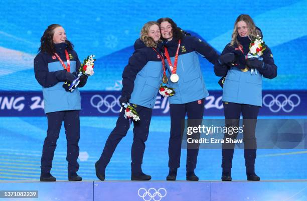 Gold medallists Linn Persson, Mona Brorsson, Hanna Oeberg and Elvira Oeberg of Team Sweden celebrate during the Women's Biathlon 4x6km Relay medal...