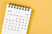 June 2022 desk calendar on light yellow background.