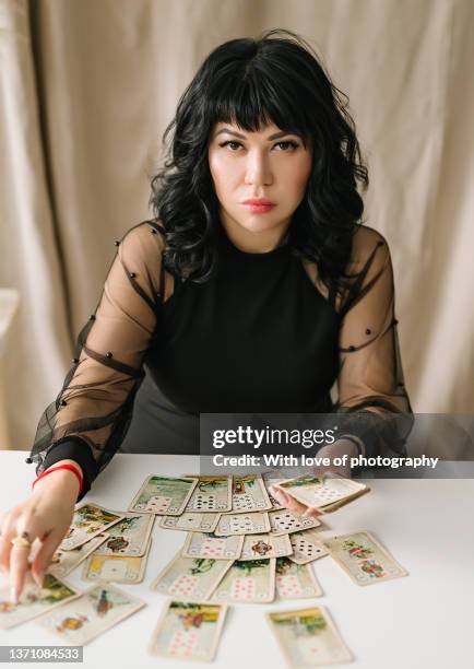 woman fortune-teller making predictions, astrologist, tarot cards in hands - tarot cards stock-fotos und bilder