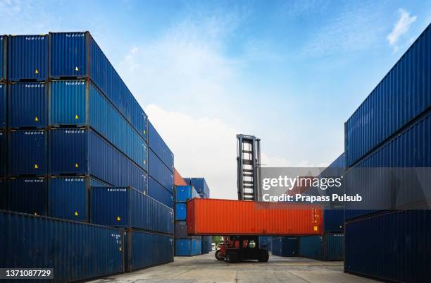 crane lifting up container in yard - container foto e immagini stock