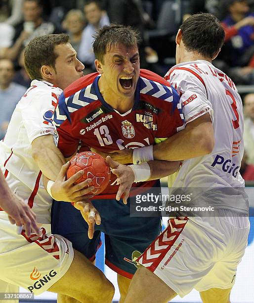 Serbia's Momir Ilic in action against Poland Krzysztof Lijewski during the Men's European Handball Championship group A match between Poland and...