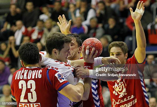 Poland's Mariusz Jurkiewicz in action against Serbia's Nenad Vuckovic and Momir Ilic during the Men's European Handball Championship group A match...