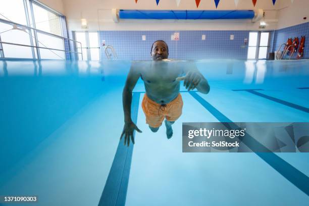 trying his best - swimming lessons stock pictures, royalty-free photos & images