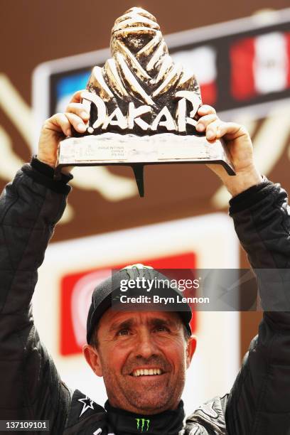 Stephane Peterhansel of France celebrates winning the car category of the 2012 Dakar Rally from Pisco to Lima on January 15, 2012 in Lima, Peru.