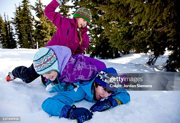 three children (10-12, 13-15) playing on snow - newfriendship stock pictures, royalty-free photos & images