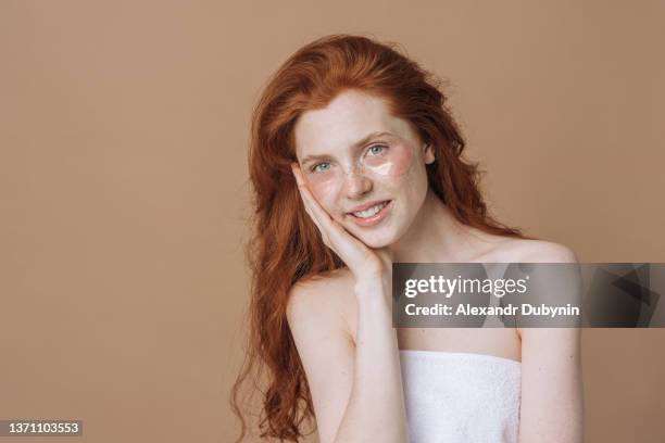 happy redhead woman with facial patches. skin care concept. - aloe vera gel stock-fotos und bilder