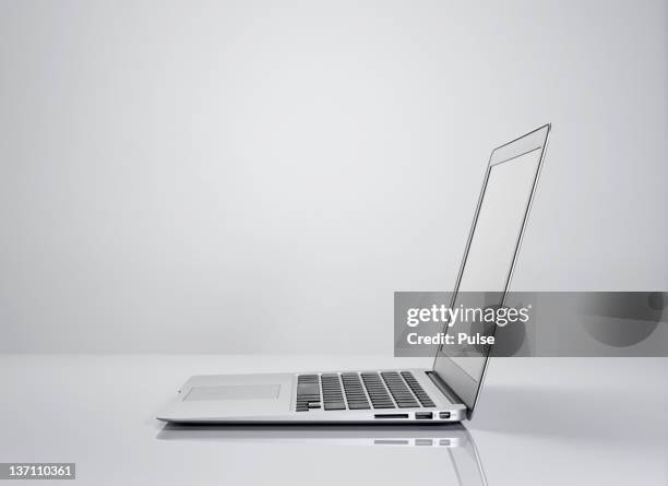 studio shot of silver laptop. - laptop side view stock pictures, royalty-free photos & images