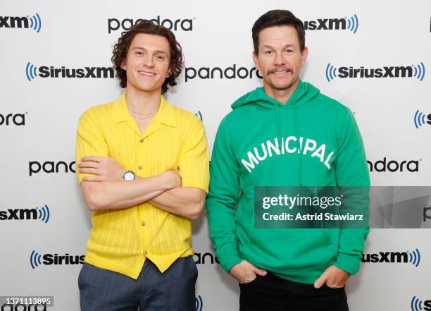 Actors Tom Holland and Mark Wahlberg visit the SiriusXM Studios on February 17, 2022 in New York City.