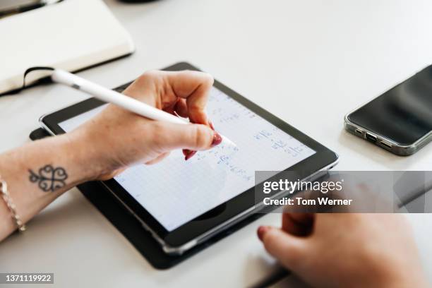 close up student writing on digital tablet - school close up stock-fotos und bilder