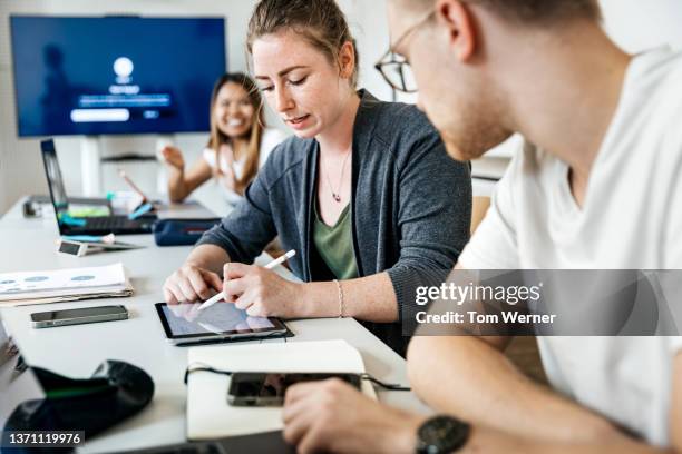 two colleagues discussing task during college seminar session - tech training course stock pictures, royalty-free photos & images