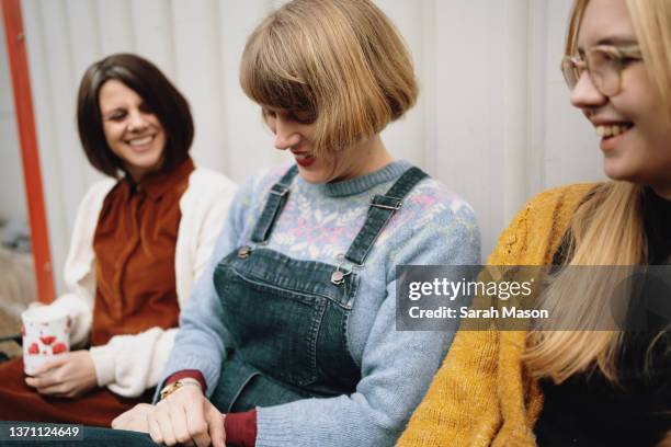 three female colleagues sat chatting - femalefocuscollection stock pictures, royalty-free photos & images