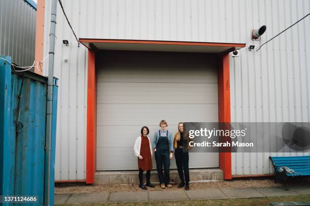 three colleagues standing outside industrial cabin - wide shot stock pictures, royalty-free photos & images