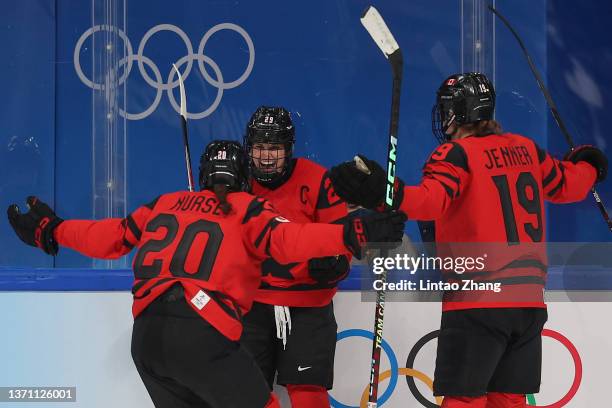 Marie-Philip Poulin of Team Canada celebrates with teammates after scoring a goal in the second period during the Women's Ice Hockey Gold Medal match...