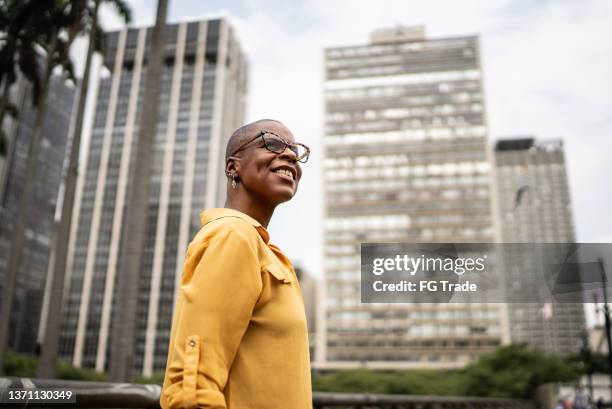 contemplative mature woman looking away in the city - mature black woman looking away stock pictures, royalty-free photos & images