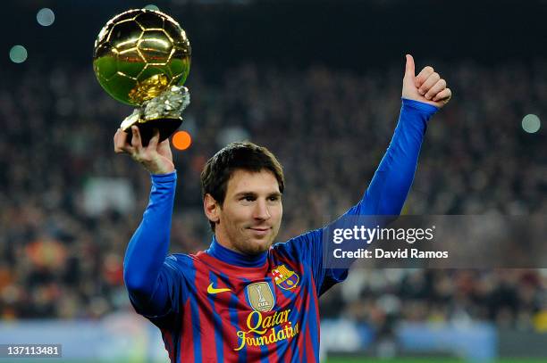 Lionel Messi of FC Barcelona holds the Ballon d'Or trophy prior to the La Liga match between FC Barcelona and Real Betis Balompie at Camp Nou on...