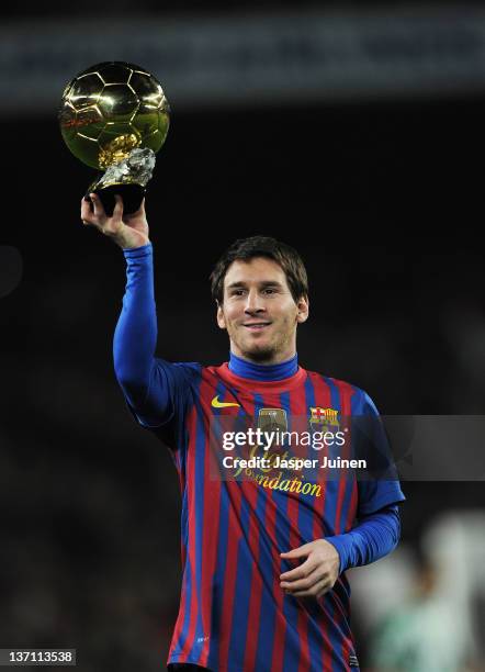 Lionel Messi of FC Barcelona shows the FIFA Ballon d'Or to the home crowd at the start of the la Liga match between FC Barcelona and Real Betis...
