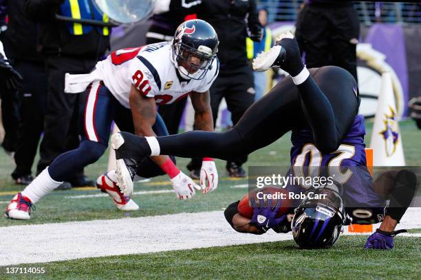 Ed Reed of the Baltimore Ravens tumbles after intercepting the ball against Andre Johnson of the Houston Texans during the fourth quarter of the AFC...