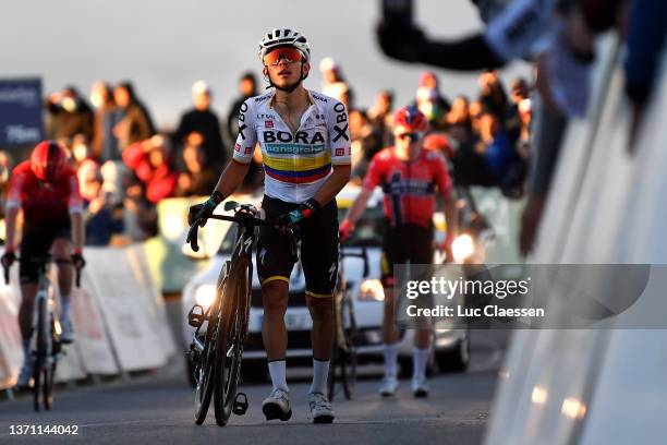 Sergio Andres Higuita Garcia of Colombia and Team Bora - Hansgrohe crosses the finishing line injured after being involved in a crash during the 48th...