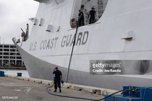 Coast Guard crew members work on the Cutter James as packages of cocaine and marijuana are offloaded at Port Everglades on February 17, 2022 in Fort...