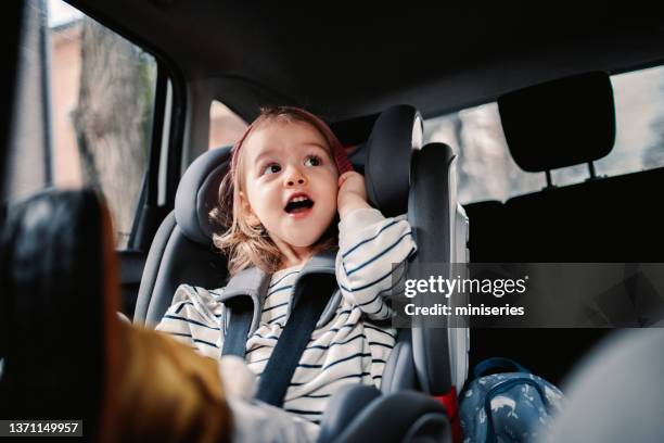 happy little girl enjoy traveling by car - car interior stock pictures, royalty-free photos & images