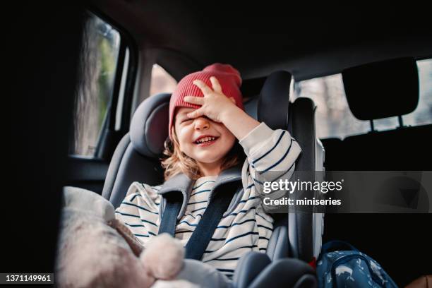 happy little girl enjoy traveling by car - kid car seat stock pictures, royalty-free photos & images