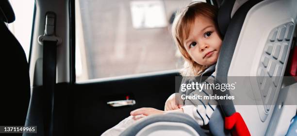 portrait of a little girl enjoy traveling by car - safe kids day stock pictures, royalty-free photos & images