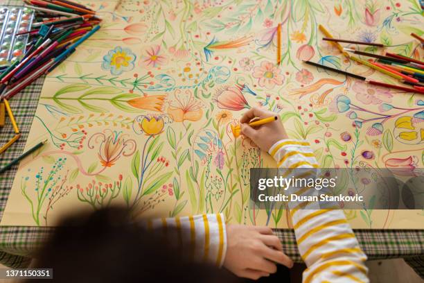 visão de ângulo alto de menino criativo irreconhecível desenhando as plantas e flores - desenhar atividade - fotografias e filmes do acervo
