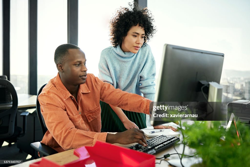 Young business partners working on project in modern office