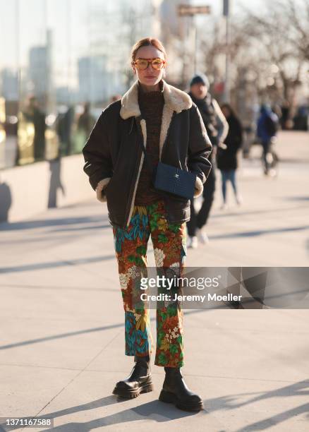 Hannah Baxter is seen wearing brown coat and floral pants outside Peter Do during New Yorker Fashion Week on February 15, 2022 in New York City.