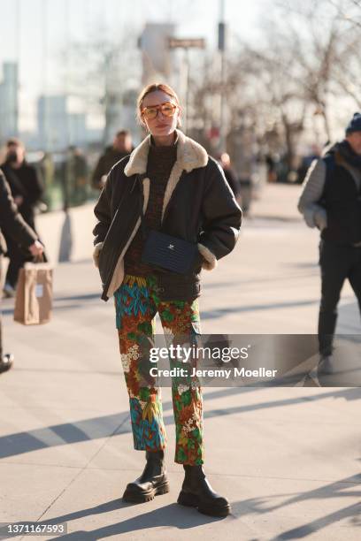 Hannah Baxter is seen wearing brown coat and floral pants outside Peter Do during New Yorker Fashion Week on February 15, 2022 in New York City.