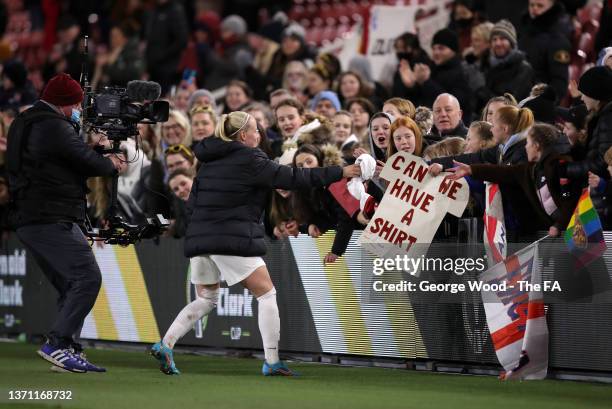 Beth Mead of England gives their shirt to a fan holding a sign after the Arnold Clark Cup match between England and Canada at Riverside Stadium on...