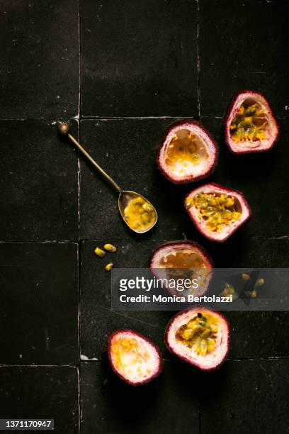 passion fruit halved on black background, with copy space - food abundance stock pictures, royalty-free photos & images