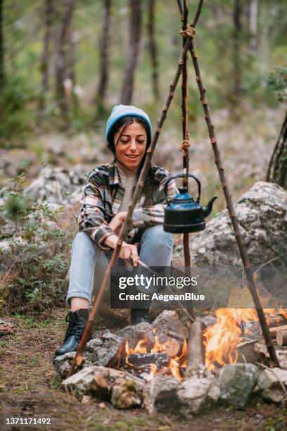 beautiful woman by the campfire - bonfire stock pictures, royalty-free photos & images