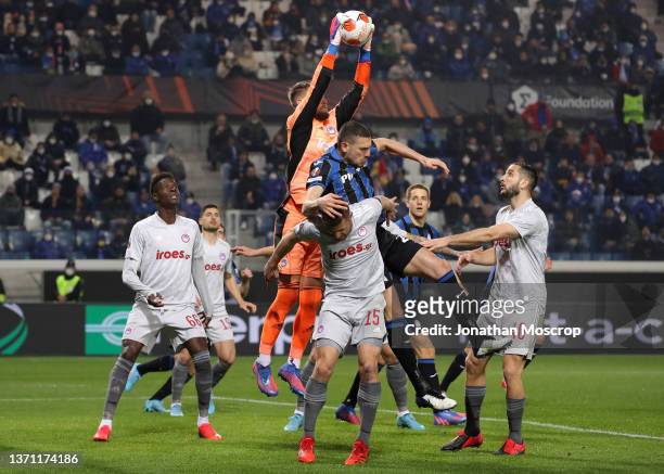 Tomas Vaclik of Olympiacos FC makes a save against Merih Demiral of Atalanta during the UEFA Europa League Knockout Round Play-Offs Leg One match...