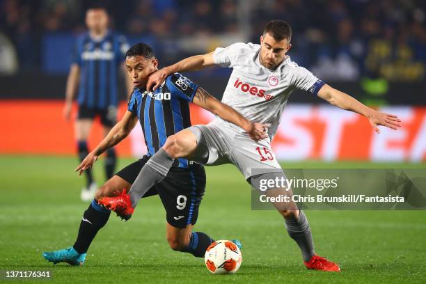 Luis Muriel of Atalanta in action with Sokratis Papastathopoulos of Olympiakos during the UEFA Europa League Knockout Round Play-Offs Leg One match...