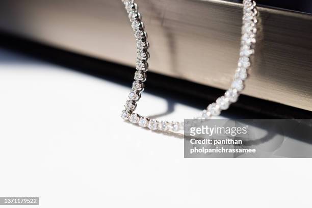 close up shot minimal diamond necklace. concept for luxury accessory - high collar fotografías e imágenes de stock