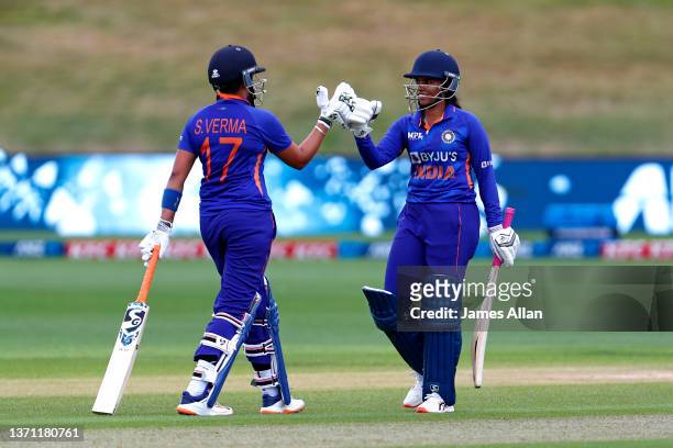 Indian player S Meghana celebrates her half century with team mate Shafali Verma during game three in the One Day International series between the...