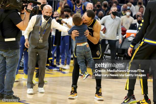 Golden State Warriors' Stephen Curry kisses his son Canon after he delivered the All-Star ring during their All-Stars jerseys presentation before the...
