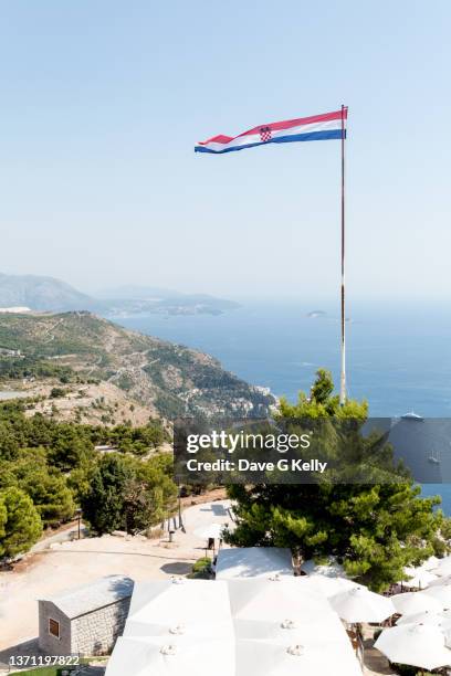 scenic mountain top view of sea with croatian flag - croatian flag foto e immagini stock