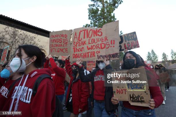 Stanford students hold signs as they stage a protest outside of Dinkelspiel Auditorium where former U.S. Vice President Mike Pence is scheduled to...