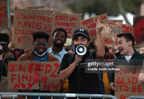 Stanford students hold signs as they stage a protest outside of Dinkelspiel Auditorium where former U.S. Vice President Mike Pence is scheduled to...
